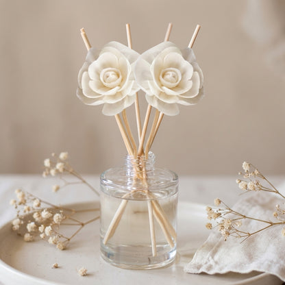 Reed diffuser bottle with reeds, in soft romantic garden florals