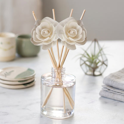 Reed diffuser bottle with reeds, in crisp linen and cotton scents