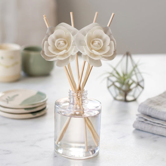 Reed diffuser bottle with reeds, in crisp linen and cotton scents